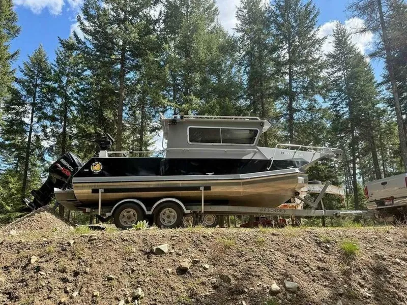 Slide: The Image of 2005 ACB 27 boat on trailer in forested area, sunny day. - 57