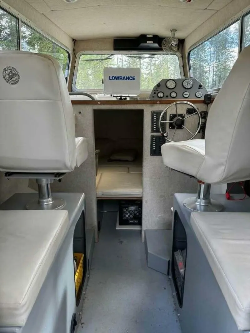 Slide: The Image of Interior of a 2005 ACB 27 boat with steering wheel and navigation equipment. - 58