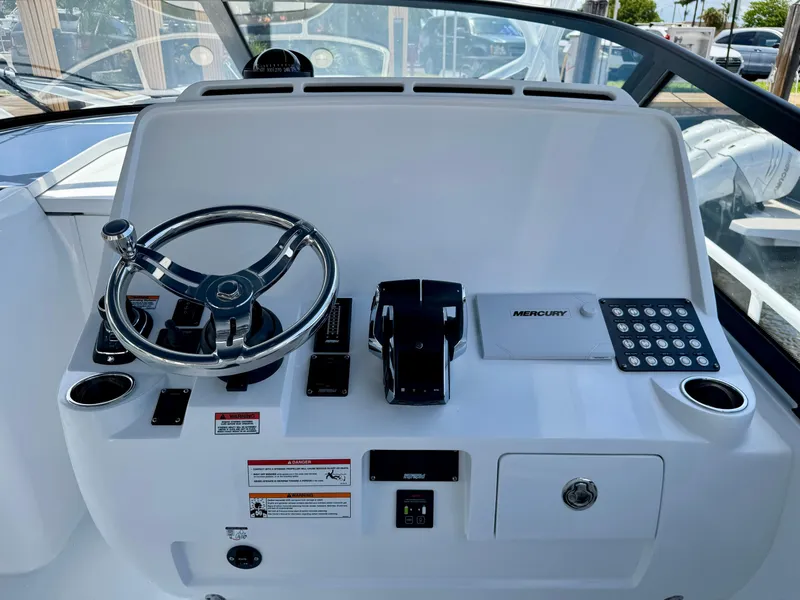 Slide: The Image of Helm of 2026 Intrepid 438 Evolution boat with steering wheel and controls. - 11