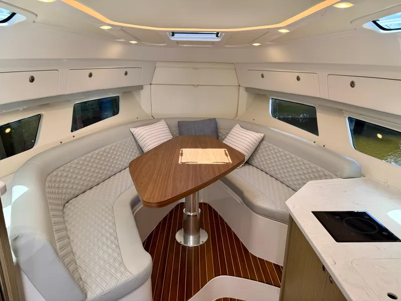 Slide: The Image of Luxurious interior of 2026 Intrepid 438 Evolution yacht with elegant seating and wooden table. - 13