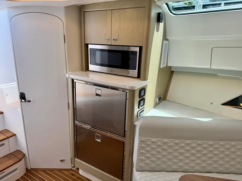 Slide: The Image of Interior of 2026 Intrepid 438 Evolution yacht with modern kitchen appliances. - 14