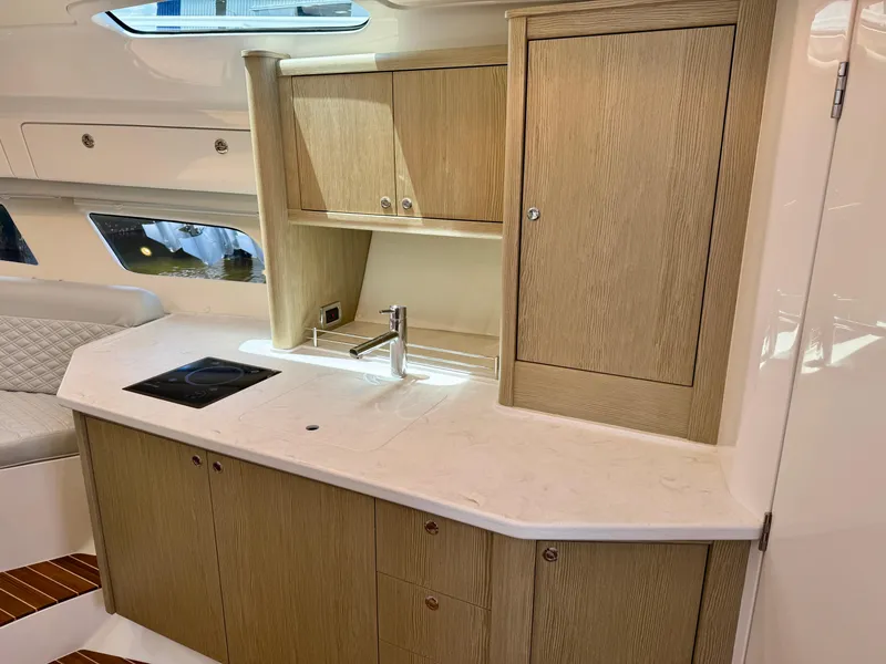 Slide: The Image of Modern kitchen area in 2026 Intrepid 438 Evolution yacht with wood cabinetry and sleek countertop. - 15