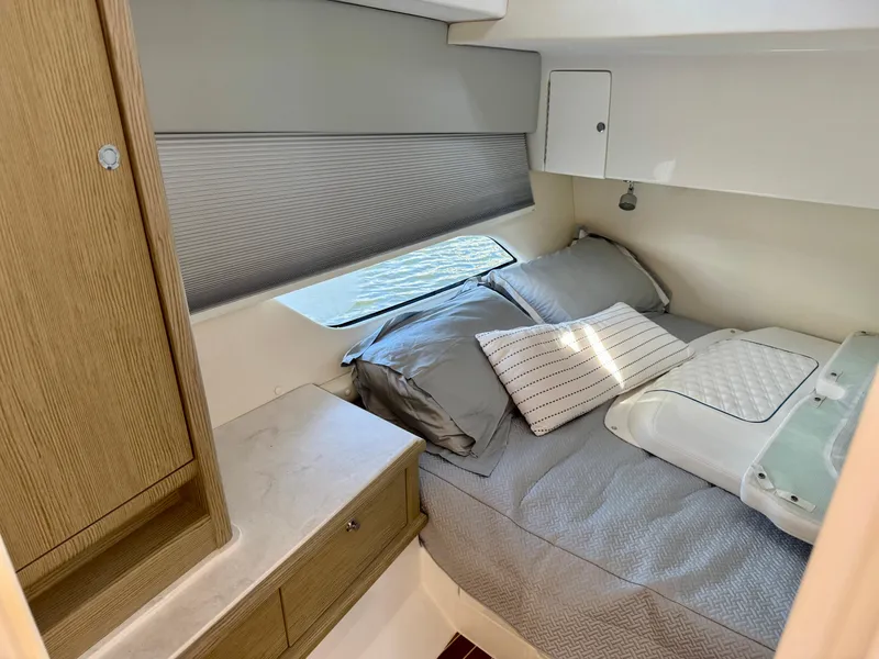 Slide: The Image of Cozy cabin interior of 2026 Intrepid 438 Evolution yacht with bed and wooden cabinetry. - 17