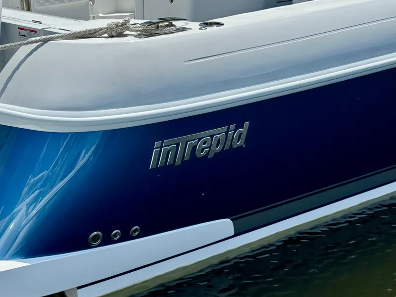 Slide: The Image of 2026 Intrepid 438 Evolution boat with sleek blue and white design. - 3