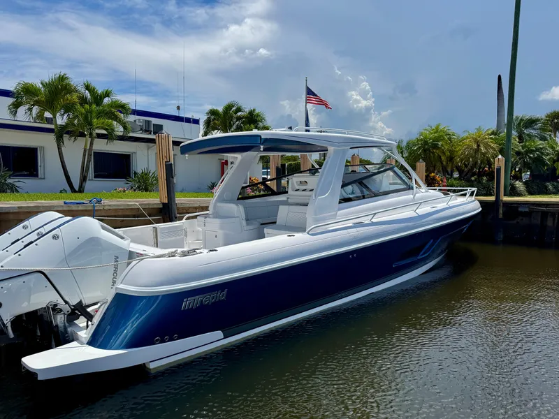Slide: The Image of 2026 Intrepid 438 Evolution boat docked, featuring sleek design and powerful engines. - 4