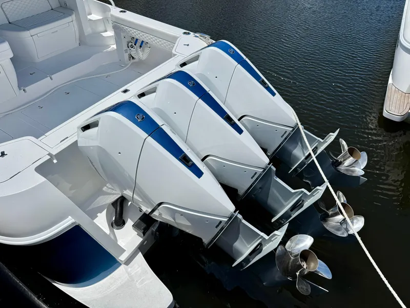 Slide: The Image of 2026 Intrepid 438 Evolution boat with triple outboard engines on water. - 6