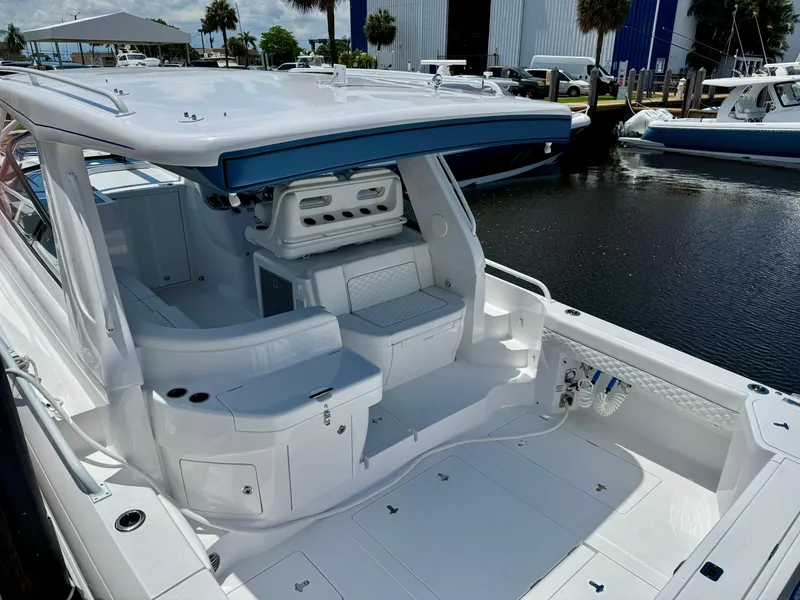 Slide: The Image of 2026 Intrepid 438 Evolution yacht interior, featuring sleek white seating and modern design. - 7