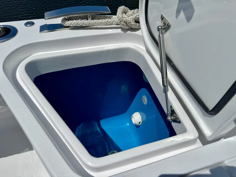 Slide: The Image of Open storage compartment on 2026 Intrepid 438 Evolution boat, featuring a blue interior. - 9