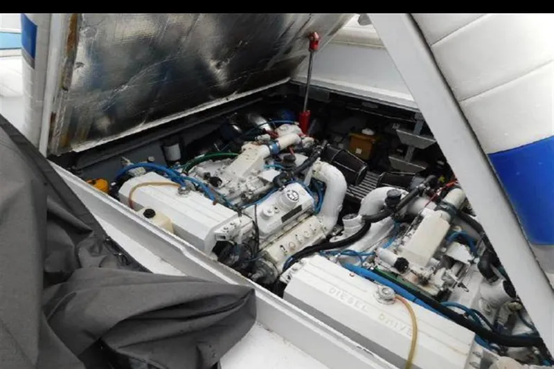Slide: The Image of Engine compartment of a 1988 Magnum 40 Sport boat, showcasing dual engines. - 13