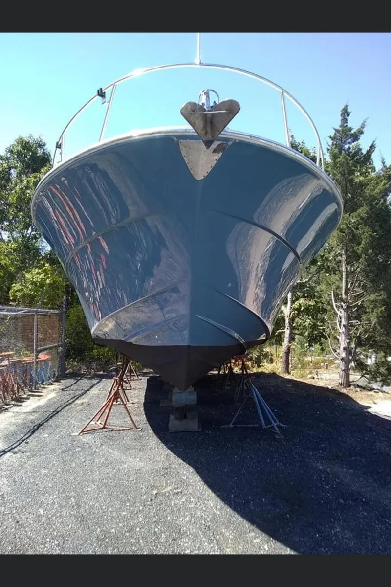 Slide: The Image of 1988 Magnum 40 Sport boat on stands, front view, outdoors. - 18