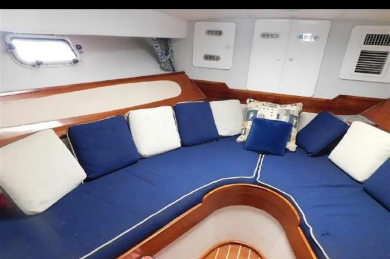 Slide: The Image of Interior of 1988 Magnum 40 Sport boat with blue and white cushioned seating. - 23