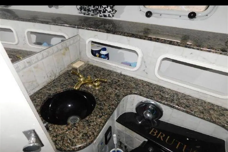 Slide: The Image of Luxurious bathroom in 1988 Magnum 40 Sport yacht with granite countertop and gold fixtures. - 25