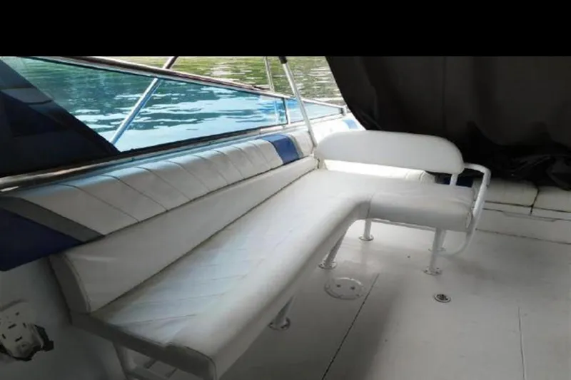 Slide: The Image of 1988 Magnum 40 Sport boat interior with white seating and blue accents. - 26