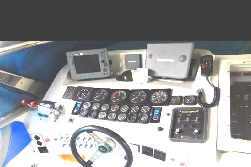 Slide: The Image of Control panel of a 1988 Magnum 40 Sport boat with gauges and navigation equipment. - 27
