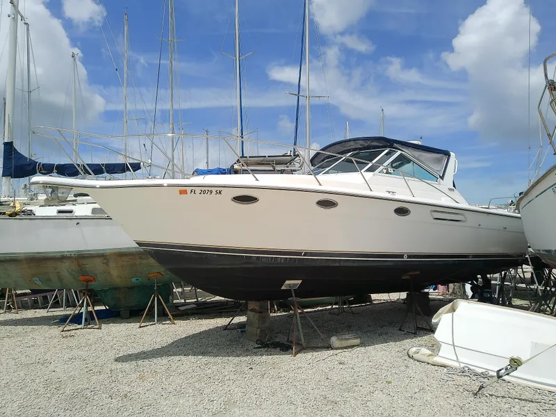 The Image of 2000 Tiara Yachts 3100 Open boat on dry dock under a clear blue sky. - 0
