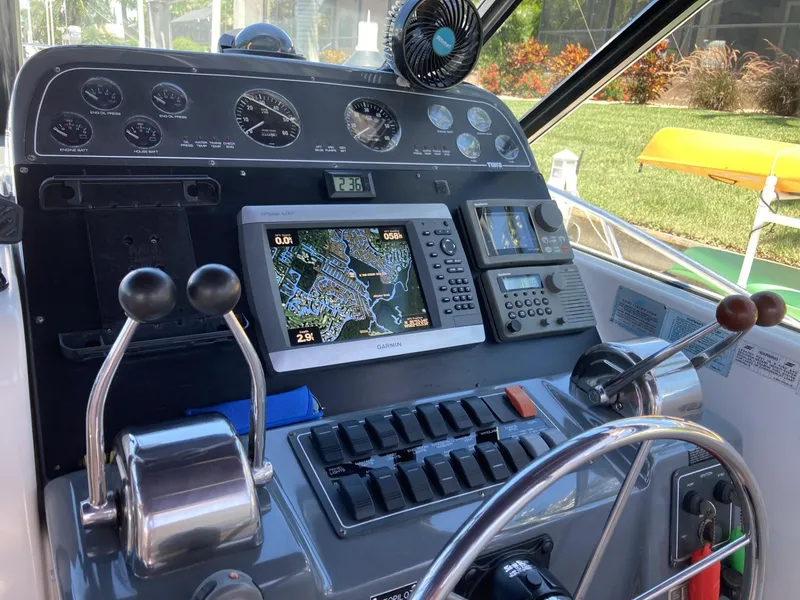 Slide: The Image of Control panel of a 2000 Tiara Yachts 3100 Open, featuring navigation and engine controls. - 12