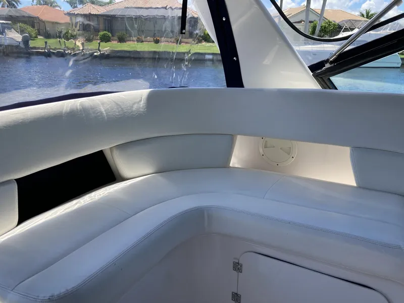 Slide: The Image of Interior seating of 2000 Tiara Yachts 3100 Open, with waterfront view. - 13