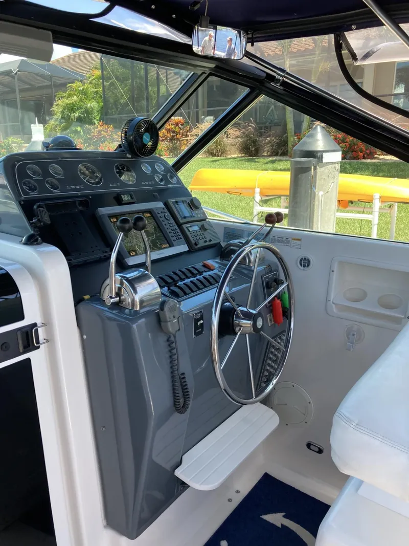 Slide: The Image of Helm of 2000 Tiara Yachts 3100 Open, featuring steering wheel and control panel. - 14