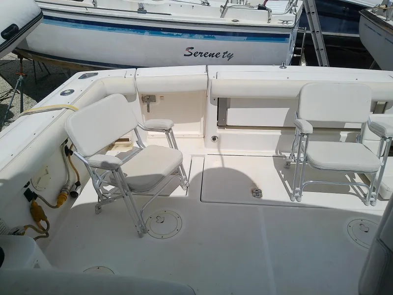 Slide: The Image of 2000 Tiara Yachts 3100 Open boat interior with white seating and deck. - 26