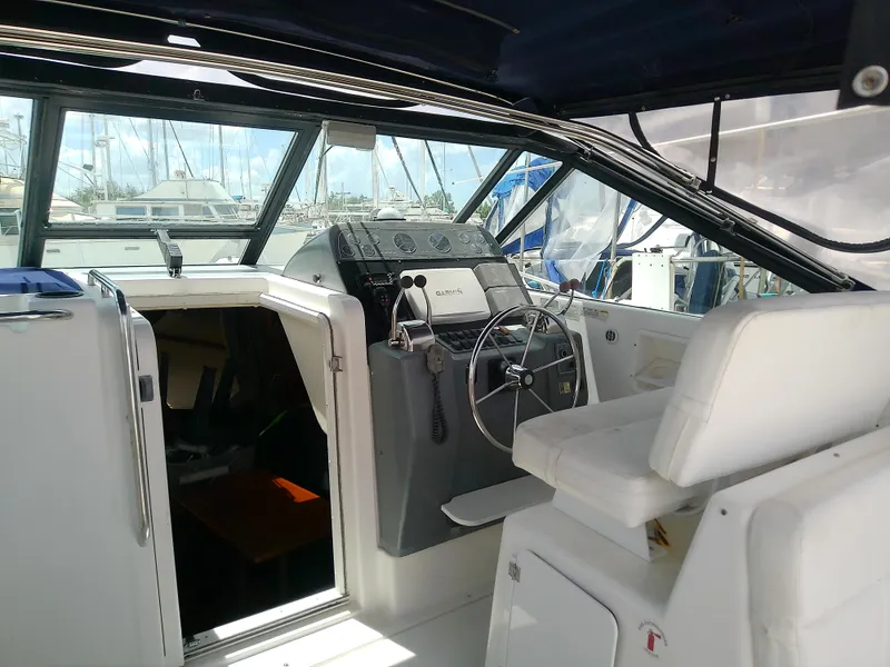 Slide: The Image of Interior view of 2000 Tiara Yachts 3100 Open, featuring helm and seating area. - 28