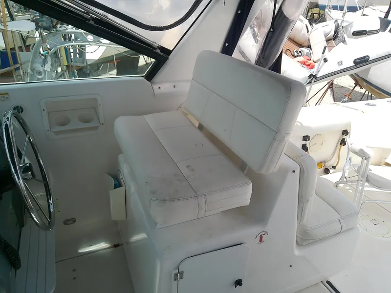 Slide: The Image of 2000 Tiara Yachts 3100 Open cockpit with white seating and steering wheel. - 31