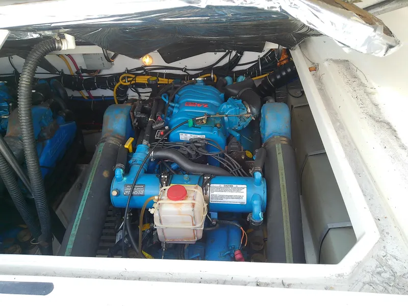 Slide: The Image of Engine compartment of a 2000 Tiara Yachts 3100 Open, showcasing blue marine engine components. - 37
