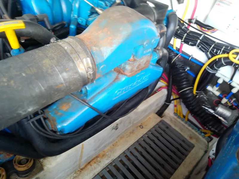 Slide: The Image of Engine compartment of a 2000 Tiara Yachts 3100 Open, featuring blue components and wiring. - 41