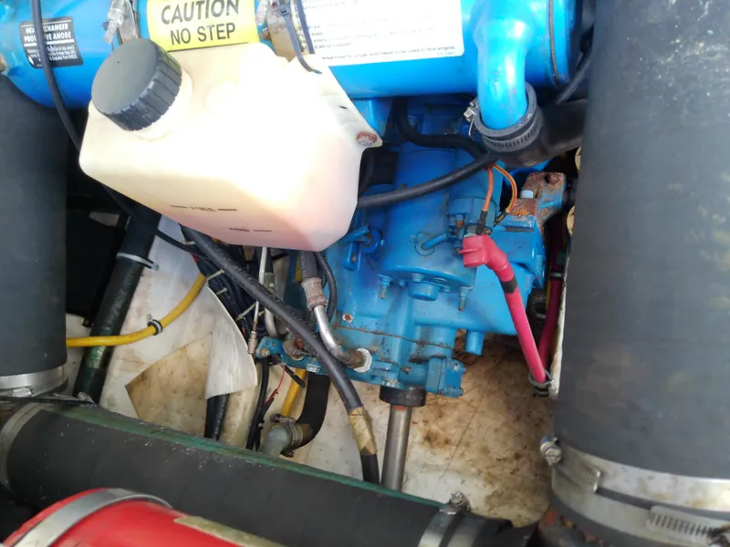 Slide: The Image of Engine compartment of a 2000 Tiara Yachts 3100 Open, featuring blue engine components. - 42