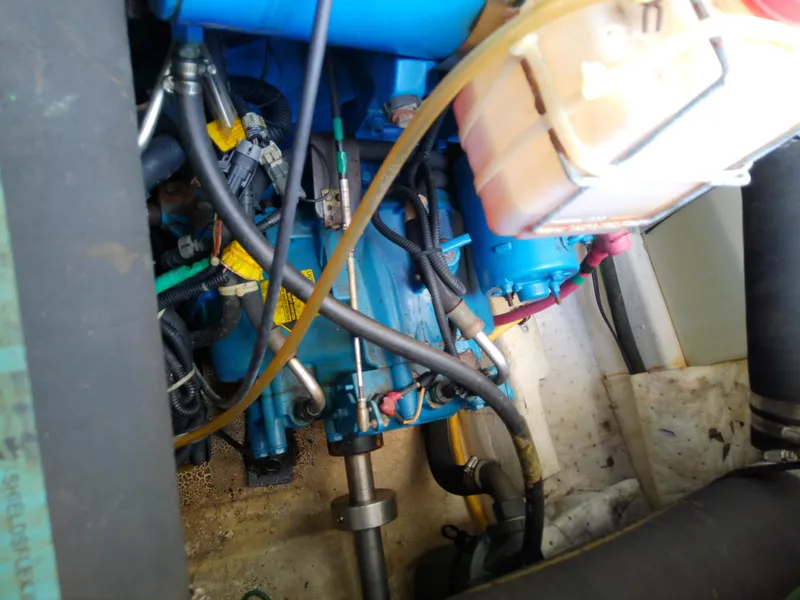 Slide: The Image of Engine compartment of a 2000 Tiara Yachts 3100 Open, showcasing mechanical components and hoses. - 43