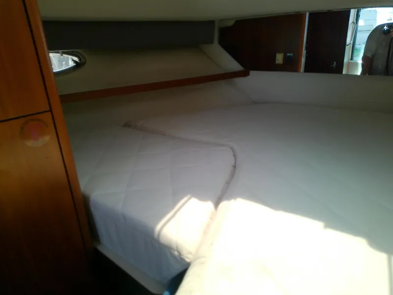 Slide: The Image of Interior cabin of 2000 Tiara Yachts 3100 Open with bed and wooden accents. - 46