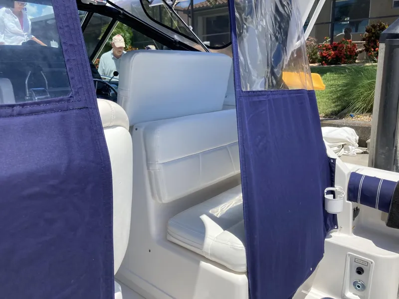 Slide: The Image of 2000 Tiara Yachts 3100 Open interior with white seating and blue curtains. - 5