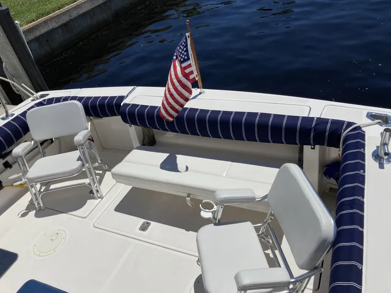 Slide: The Image of 2000 Tiara Yachts 3100 Open boat deck with seating and American flag. - 7