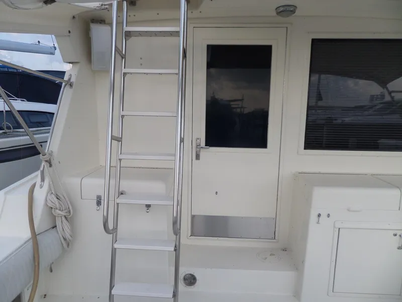 Slide: The Image of 1987 Hatteras 42 Convertible yacht deck with ladder and door. - 11