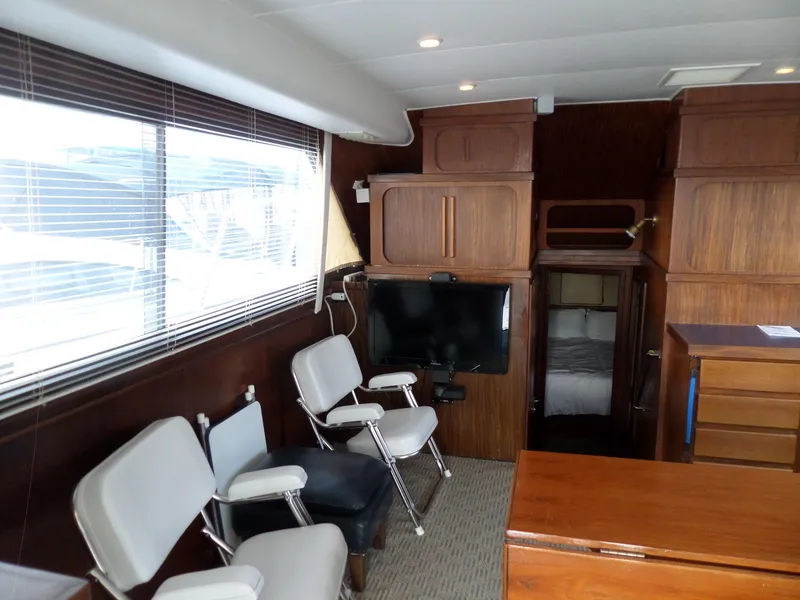 Slide: The Image of Interior of 1987 Hatteras 42 Convertible yacht with wooden cabinetry and seating. - 16