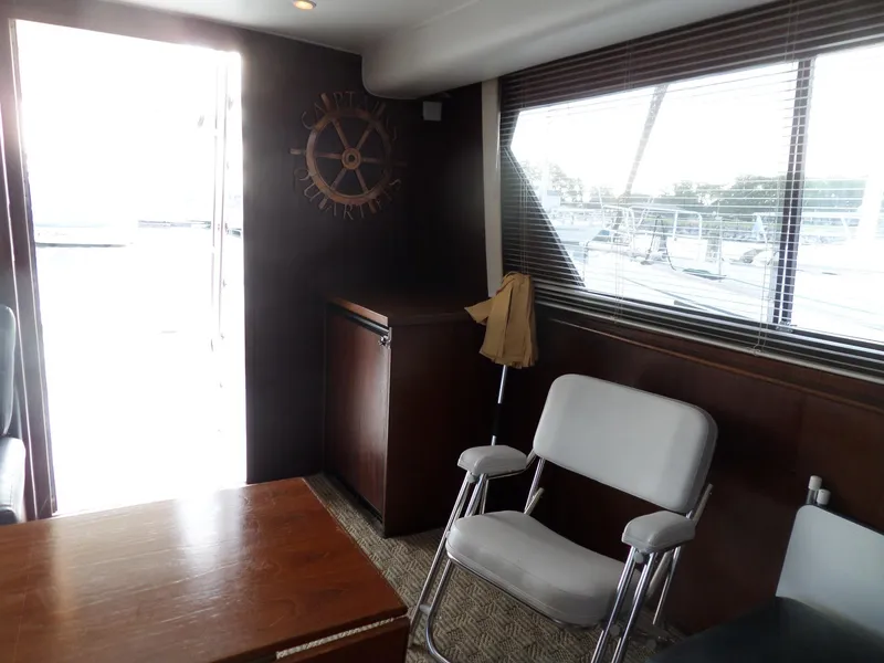Slide: The Image of Interior of 1987 Hatteras 42 Convertible yacht with seating and nautical decor. - 20