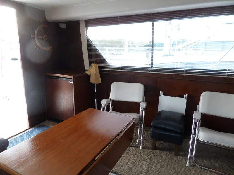 Slide: The Image of Interior of 1987 Hatteras 42 Convertible yacht with chairs and wooden table. - 21