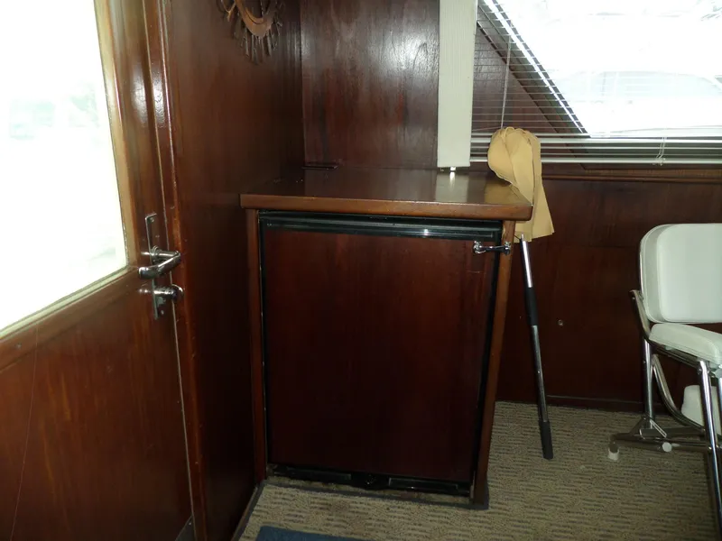 Slide: The Image of Interior of 1987 Hatteras 42 Convertible yacht with wooden cabinetry and seating. - 22