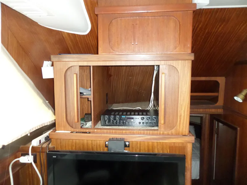 Slide: The Image of Interior of 1987 Hatteras 42 Convertible yacht with wooden cabinetry and electronic equipment. - 25