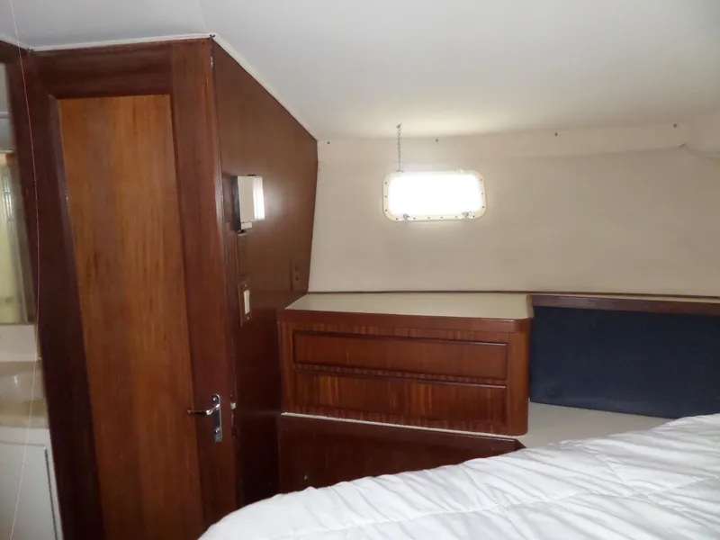 Slide: The Image of Interior cabin of 1987 Hatteras 42 Convertible yacht with wood paneling and window. - 29