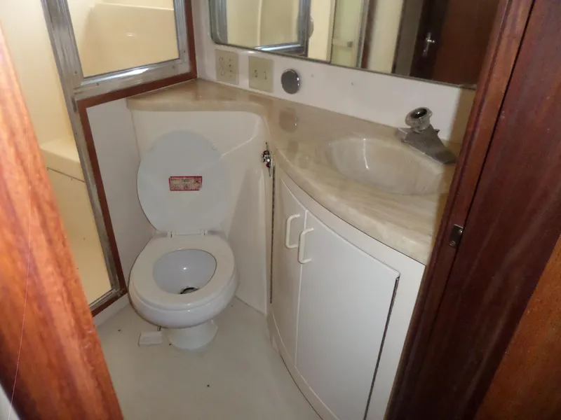 Slide: The Image of Bathroom interior of 1987 Hatteras 42 Convertible yacht with toilet and sink. - 31