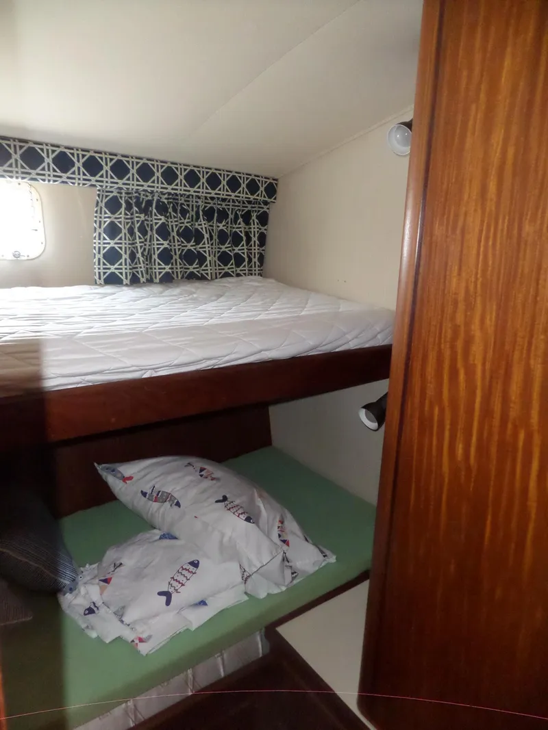 Slide: The Image of Interior cabin of 1987 Hatteras 42 Convertible with bunk beds and nautical decor. - 37
