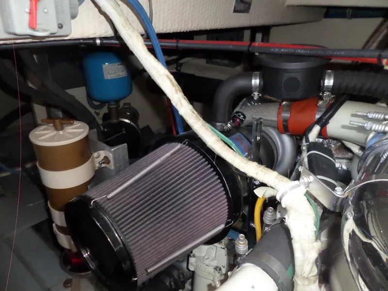 Slide: The Image of Engine room of 1987 Hatteras 42 Convertible boat, showcasing mechanical components. - 44