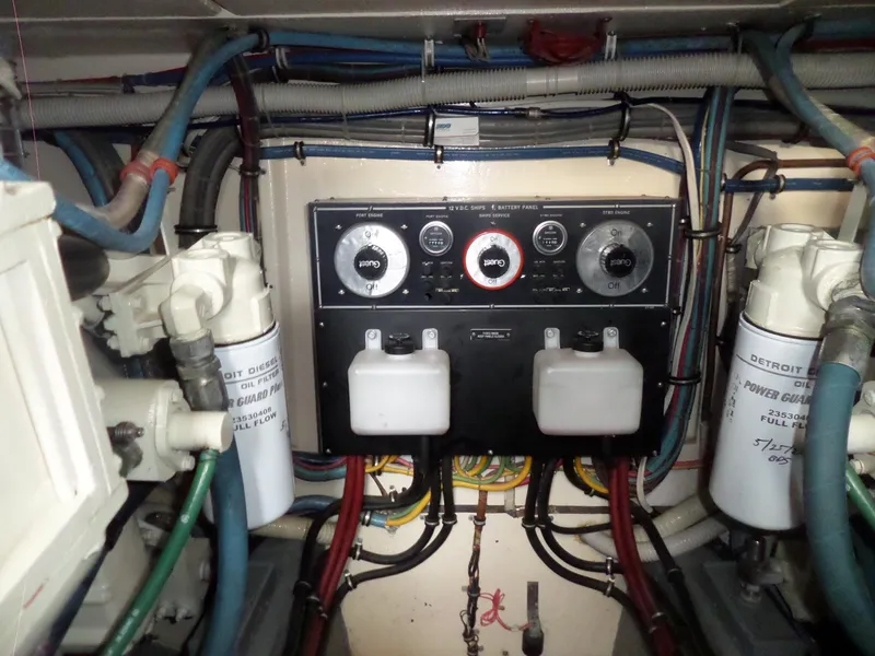 Slide: The Image of Engine room of 1987 Hatteras 42 Convertible with control panel and filters. - 45
