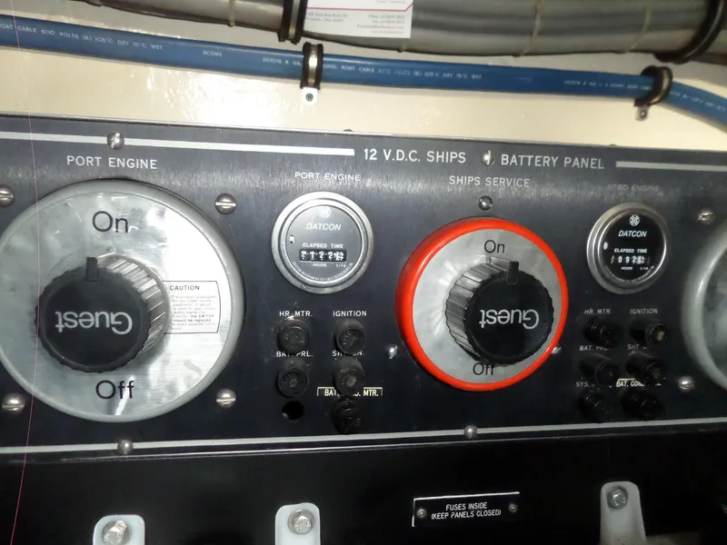 Slide: The Image of Control panel of a 1987 Hatteras 42 Convertible boat with engine switches and gauges. - 46