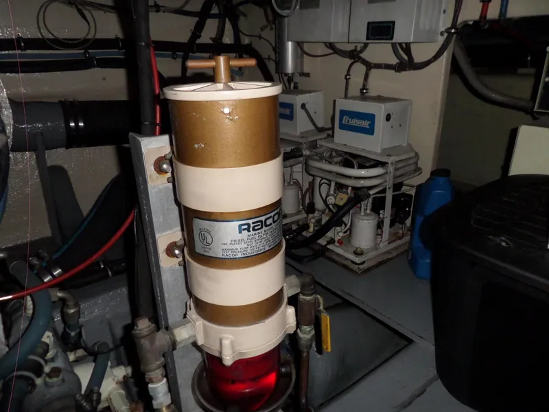 Slide: The Image of Engine room of 1987 Hatteras 42 Convertible with Racor fuel filter system. - 49