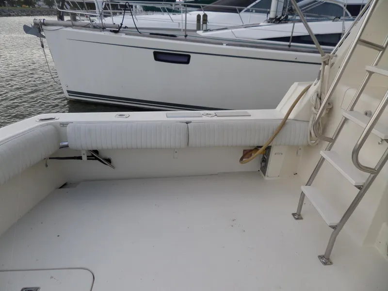 Slide: The Image of 1987 Hatteras 42 Convertible yacht deck with seating and ladder. - 6