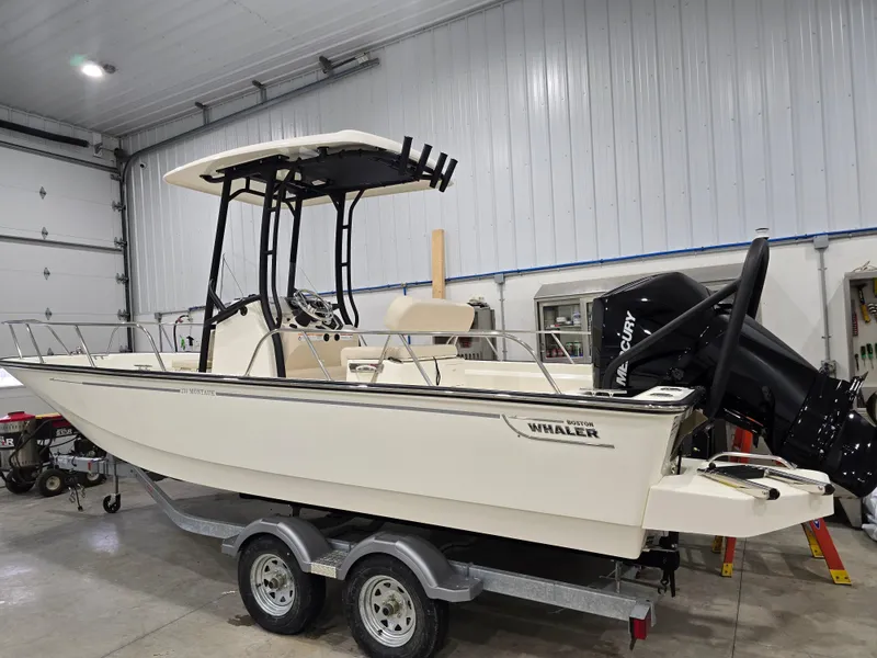 The Image of 2025 Boston Whaler 210 Montauk boat in a garage, on a trailer. - 1