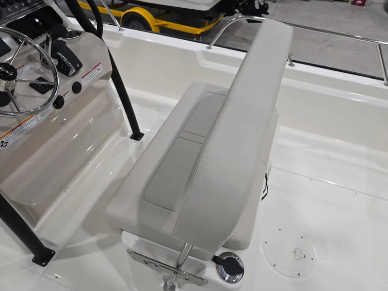 Slide: The Image of 2025 Boston Whaler 210 Montauk boat interior with steering console and seating. - 18