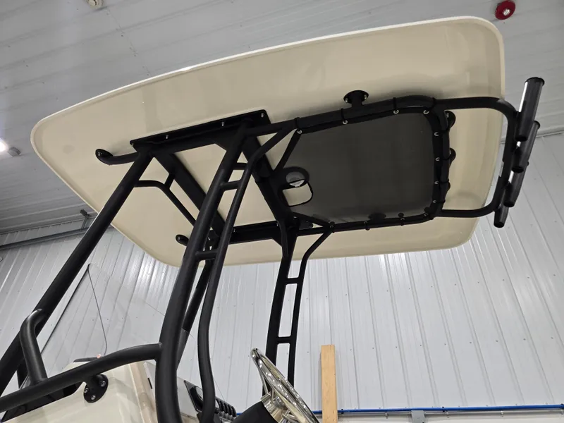 Slide: The Image of 2025 Boston Whaler 210 Montauk T-top structure in a boat showroom. - 3