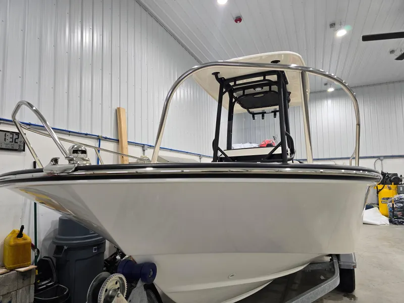 Slide: The Image of 2025 Boston Whaler 210 Montauk boat in a garage, showcasing its sleek design. - 4